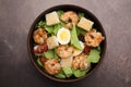 Delicious Caesar salad with shrimps on brown table, top view Royalty Free Stock Photo