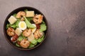 Delicious Caesar salad with shrimps on brown table, top view. Space for text Royalty Free Stock Photo