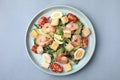 Delicious Caesar salad with shrimps on grey background, top view Royalty Free Stock Photo