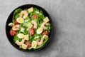 Delicious Caesar salad with shrimps on grey table, top view. Space for text Royalty Free Stock Photo