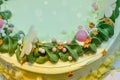 Delicious Cake and beautiful decoration. banana cakes on a green plate white background Top view . New Year`s cake. Your