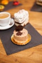 Delicious cake with brown glaze and delicious biscuit on top over a wooden table in a coffee shop Royalty Free Stock Photo