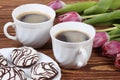 Delicious cake with coffe and tulips on table Royalty Free Stock Photo