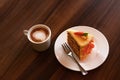 Delicious cake and cup of hot coffee on wooden table Royalty Free Stock Photo