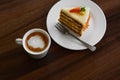Delicious cake and cup of hot coffee on wooden table, above view Royalty Free Stock Photo