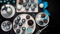 Delicious cake and cupcakes in blue on dark background. Table setting for celebration Royalty Free Stock Photo
