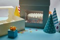 Delicious cake with meringues in box, cupcakes, gift and party hats