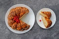 Slices of cake on a plate. Berries of a cherry on a cake. Strawberry and creamy filling. Royalty Free Stock Photo