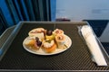 Delicious canape finger food appetizers served on airplane business class seats. Royalty Free Stock Photo