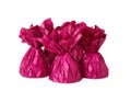 Delicious candies in pink wrappers on white background Royalty Free Stock Photo