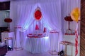 delicious candy bar at luxury wedding reception in red colors . exclusive expensive catering. table with modern desserts Royalty Free Stock Photo