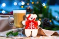 Delicious cappucino glass cup with christmas teddy bear gingerbread cookie. fireflies and spruce branches background