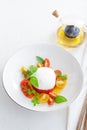 Delicious caprese salad with ripe cherry tomatoes and mozzarella cheese with fresh basil leaves and olive oil. Italian Royalty Free Stock Photo