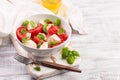 Delicious caprese salad with ripe tomatoes and mozzarella cheese with fresh basil leaves. Italian food. Royalty Free Stock Photo