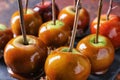 Delicious caramel apples with tree branches on slate plate Royalty Free Stock Photo