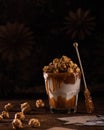 Delicious caramel milkshake with sweet popcorn on a dark background. Royalty Free Stock Photo