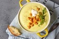 Delicious cauliflower soup with curry and cream in a bowl garnish roasted chickpea and arugula served with artisan bread. Royalty Free Stock Photo