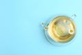 Delicious chamomile tea in glass cup on blue background, top view. Space for text Royalty Free Stock Photo