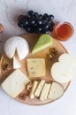 Delicious cheese mix with grapes, jam, snacks, crackers, walnuts Royalty Free Stock Photo