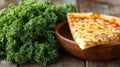 Delicious cheese pizza slice served with fresh kale on rustic wooden table Royalty Free Stock Photo