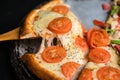 Cheese stringy slice lifted of full supreme vegan pizza baked fresh out of the oven next to ingredients Royalty Free Stock Photo