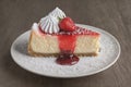 Delicious Cheesecake with a layer of strawberry compote and a dusting of powdered sugar