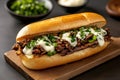 Delicious cheesesteak sandwich with melted cheese and caramelized onions on rustic board Royalty Free Stock Photo