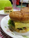 Delicious cheezy burger making with sisters Royalty Free Stock Photo