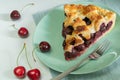 Tasty cherry pie slice with ripe cherries on a green plate Royalty Free Stock Photo