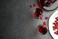 Delicious cherry wine with ripe juicy berries on grey table, flat lay. Space for text Royalty Free Stock Photo