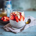 Delicious chia seed pudding with greek yogurt, strawberries, and almonds on rustic blue table Royalty Free Stock Photo