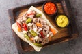 Delicious Chicago Italian beef sandwich with slow cooked beef and Giardanarra close-up on a wooden tray. horizontal top view