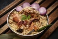 Delicious chicken biryani top view.Biryani rice dish Beautiful Indian rice dish.Delicious spicy chicken biryani in bowl over moody Royalty Free Stock Photo