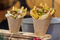 Delicious chicken and fries wrap street food with cheddar cheese sauce on the top, fast food buffet