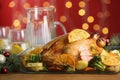 Delicious chicken with oranges and vegetables on table against blurred festive lights, closeup Royalty Free Stock Photo