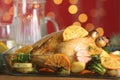 Delicious chicken with oranges and vegetables on table against blurred festive lights Royalty Free Stock Photo