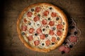 delicious chicken pizza with sausages and mushroom. dark wooden table background
