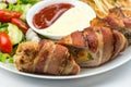 Delicious Chicken rolls with cheese and bacon on a plate close-up. horizontal Royalty Free Stock Photo