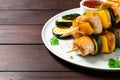 Delicious chicken shish kebabs with vegetables on wooden table, closeup. Space for text Royalty Free Stock Photo