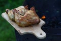 Delicious chicken thighs grilled on barbecue with burning firewood. outdoors. Free space for text Royalty Free Stock Photo