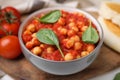 Delicious chickpea curry served on wooden board, closeup