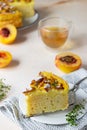 Delicious chiffon cake with custard cream and nectarines with herbal tea and thyme on light concrete background Royalty Free Stock Photo