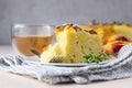 Delicious chiffon cake with custard cream and nectarines with herbal tea and thyme on light concrete background Royalty Free Stock Photo