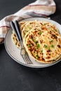 Chinese green onion pancakes on a black background. Stack of fried green onion pancakes. Dark photo Royalty Free Stock Photo