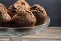 Delicious chocolate banana muffins in glass cake stand with copy space - chocolate muffin background Royalty Free Stock Photo