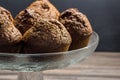 Delicious chocolate banana muffins in glass cake stand with copy space - chocolate muffin background Royalty Free Stock Photo