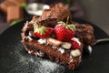 Delicious chocolate cake with berries on plate, closeup Royalty Free Stock Photo
