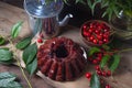 Delicious chocolate cake with berry of sweet cherry, vintage kettle and bouquet of blue flowers on dark wooden background Royalty Free Stock Photo