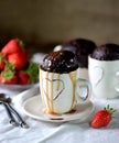 Delicious Chocolate cake cooked in a microwave in a mug with caramel syrup. Royalty Free Stock Photo