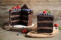 Delicious chocolate cake decorated with fresh berries on wooden table Royalty Free Stock Photo